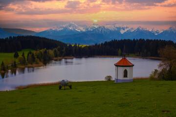 Farm chapel on a small lake ,Lake Hegratsried