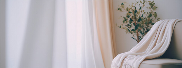 Minimalistic interior with a cream armchair and a plant in a white pot near the window with sheer curtains