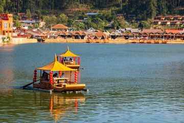 beautiful landscape Tourists sit on a boat in the lake at Ban Rak Thai, Unseen Thailand At Ban Rak Thai, Mae Hong Son Province