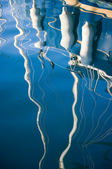 Boats in the port of Cannigione. Reflections of the masts of sailing boats. olbia. Sardinia. Italy