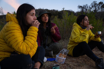 Group of mexican girls having breakfast in the countryside