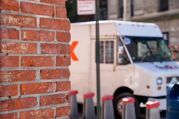 American delivery truck behind red brick wall on the street of Manhattan, New York, USA