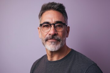 Portrait of a handsome mature man with grey beard and glasses. - obrazy, fototapety, plakaty