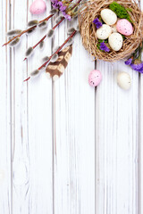 Easter banner with nest, eggs, willow, flowers and feathers.