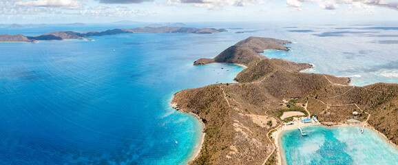 A panoramic aerial view showcasing an island in BVI surrounded by the vast ocean - obrazy, fototapety, plakaty