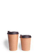 Two brown paper glasses with a lid on a white background - obrazy, fototapety, plakaty