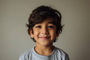 Portrait of a cute little boy in a grey t-shirt