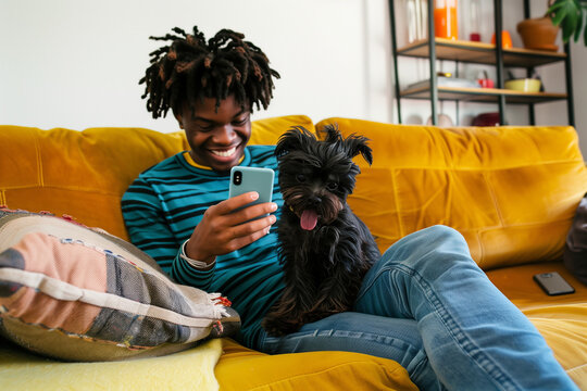 Happy Black Man on Smartphone with Cute Puppy Dog Pet