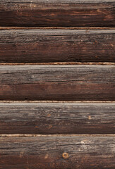 Texture of old weathered dark brown wooden log wall