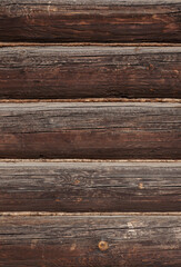 Fototapeta premium Texture of old weathered dark brown wooden log wall