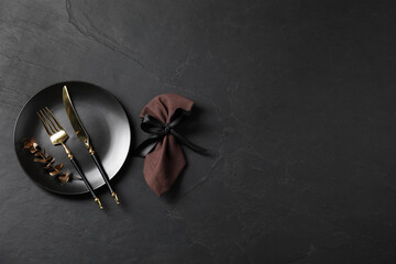 Stylish setting with elegant cutlery on grey textured table, flat lay. Space for text