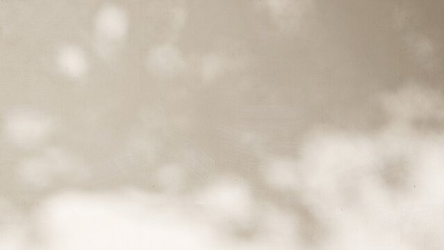 Sunlight cast dappled light and leaf foliage shadow on blank beige concrete wall for modern, luxury organic beauty, cosmetic, skincare, body care product background, exterior design decoration 3D