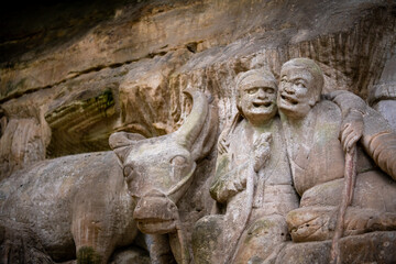 Fototapeta na wymiar Many buddhist carving at landscape of Dazu rock carving