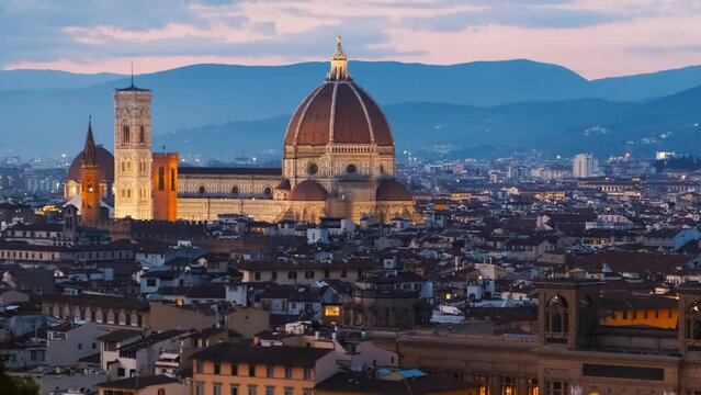Twilight establishing shot of Florence, Tuscany, Italy captures the Florence Cathedral and Palazzo Vecchio bathed in the serene glow of dusk