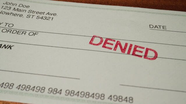 6 dolly on blank green generic check on table with denied stamp