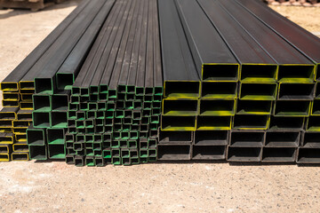 A stack of steel profiles in different shapes. They are used in construction and manufacturing. - 770207409