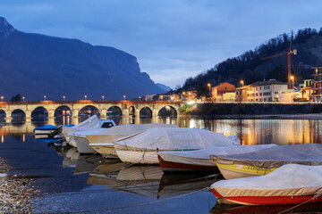 Pier and boats docked at marina on Lake Como in the harbor of the city of Lecco, Lombardy, Northern Italy - obrazy, fototapety, plakaty