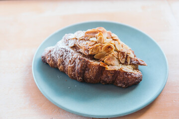 almond croissant on a blue plate