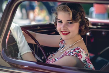 Poster Im Rahmen A young woman in her late teens is sitting in a vintage car © Veniamin Kraskov