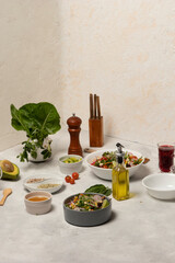 Family Vegetarian Feast with Fresh Vegetable Spread on the Dinner Table showcasing fresh vegetables, complemented by olive oil, wine, pepper, and assorted ingredients as lettuce, tomato, avocado