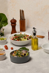 Family Vegetarian Feast with Fresh Vegetable Spread on the Dinner Table showcasing fresh vegetables, complemented by olive oil, wine, pepper, and assorted ingredients as lettuce, tomato, avocado