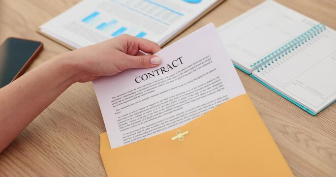 Businesswoman puts contract out envelope to close deal