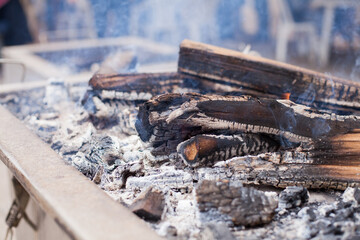Photograph of wood burning on top of a furnace called 