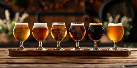 Fototapeten Variety of six different types of beer displayed on a wooden tray in front of a table © SHOTPRIME STUDIO
