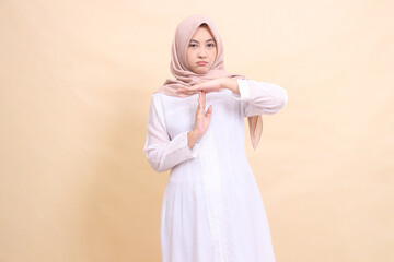 Fototapeta na wymiar woman indonesia muslim young standing frowning hands gesturing time is up. Fashion, pointer, business and promotion concept
