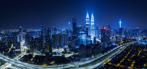 Panorama aerial view in the middle of Kuala Lumpur cityscape skyline .Night scene . - obrazy, fototapety, plakaty