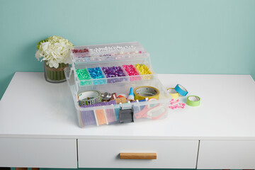 box with a set of assorted colorful buttons isolated on a white table