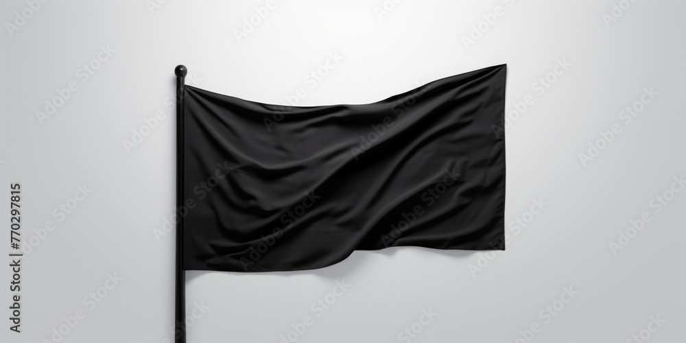 Poster a black flag is hanging from a pole. the flag is not in use and is not attached to anything