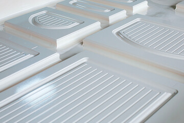 a man engineer working on a machine for sticking a film on an MDF panel close-up, the front and back background is blurred with a bokeh effect