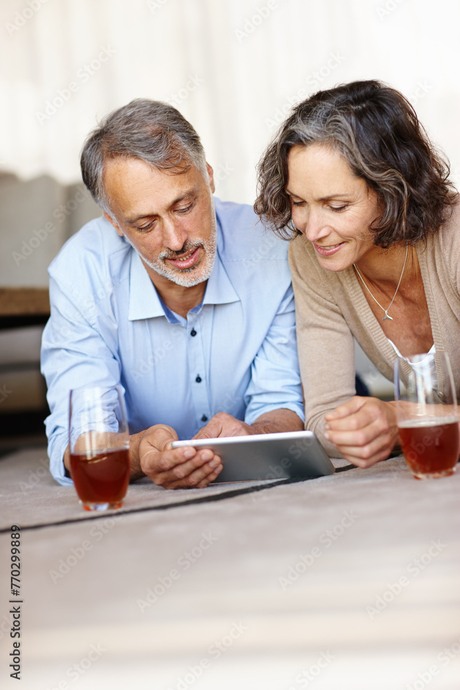 Poster Old couple on the floor, home and love with tablet, relaxing and bonding together with internet, relationship and social media. Apartment, senior woman and mature man on the ground, tech and marriage