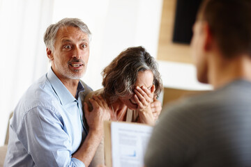 Mature couple, bad news or stress in home with surprise, crying or sad in meeting with financial...