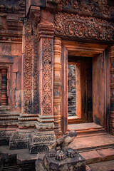 The ruin ancient statue in front of the hall way of Banteay Srei Temple in Siem Reap, Cambodia