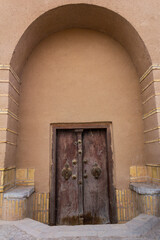 Wooden door at the entrance of an ancient house representing traditional architecture with perfect...