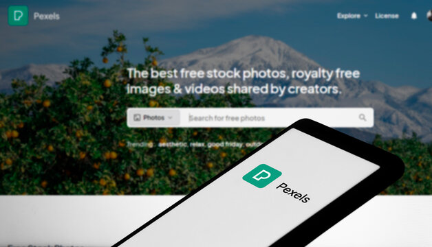 Dhaka, Bangladesh- 29 March 2024: Pexels logo is displayed on smartphone and pexels homepage on the background.