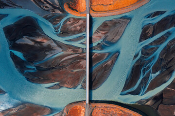 icelandic glacier river and bridge with red car view from above