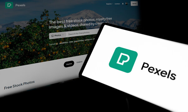 Dhaka, Bangladesh- 29 March 2024: Pexels logo is displayed on smartphone and pexels homepage on the background.