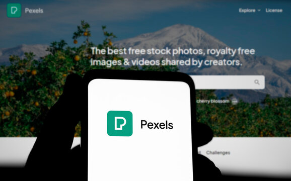 Dhaka, Bangladesh- 29 March 2024: Pexels logo is displayed on smartphone and pexels homepage on the background.