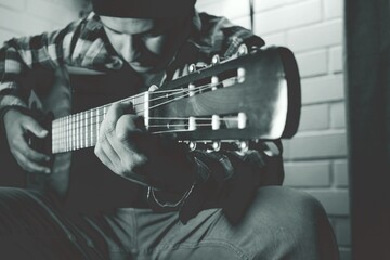 person playing guitar, black and white photography