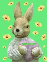 stone figurine of a bunny with a heart on a green background