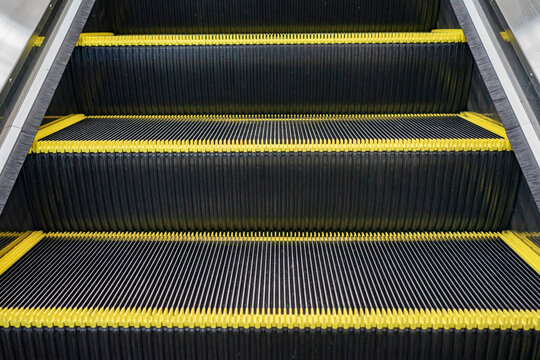 Escalator floor with copy space. Close up of the metal steps of a typical escalator. Staircase, Steps, Three Objects, Single Step, Motion