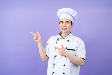 Young Asian male chef on background