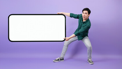 Young Asian businessman on purple background