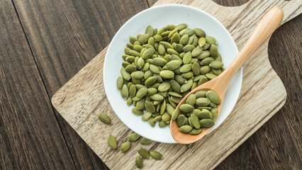 pumpkin seeds in white dish on the table
