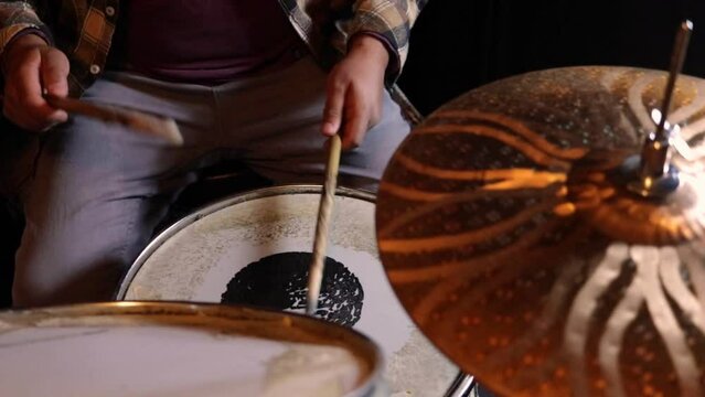 person practicing an acoustic drum set, top view