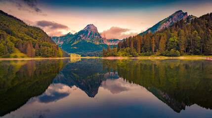 Dramatic summer sunrise on Obersee lake. Calm morning view of Swiss Alps, Nafels village location,...