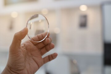 close up of a person holding a magnifying glass